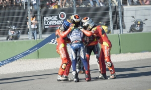 Lorenzo-is-mobbed-by-teammates-on-the-track-in-celebration-385614