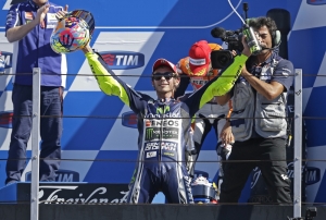 Yamaha MotoGP rider Valentino Rossi kneels on the podium after winning the San Marino Grand Prix in Misano Adriatico circuit in central Italy