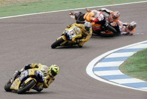 Yamaha motoGP rider Rossi takes a bend as Honda riders Pedrosa and Hayden crash out of the Portugese Grand Prix