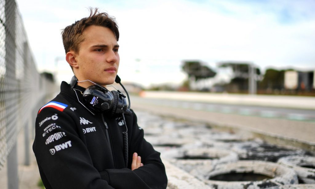 Oscar Piastri in Alpine gear, looking into the distance at Catalunya.