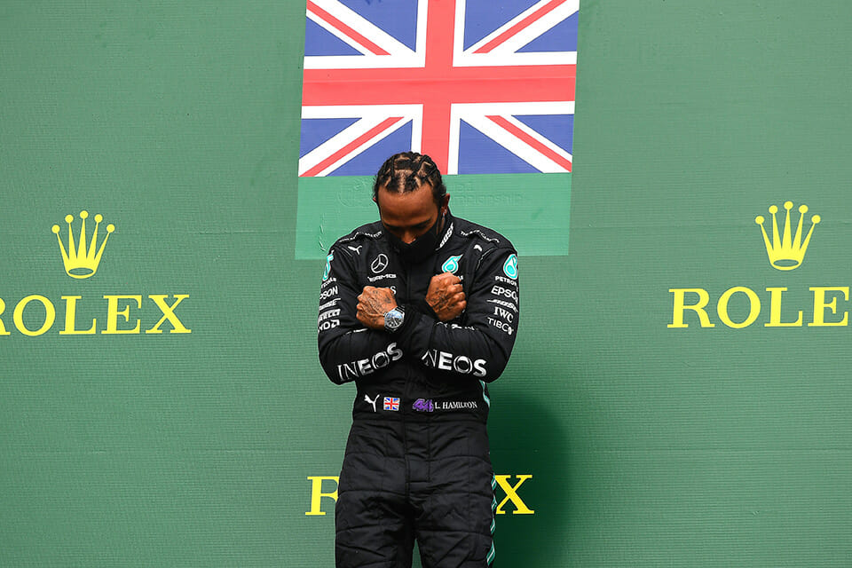 Lewis Hamilton doing the "Wakanda Forever" pose made famous by Chadwick Boseman during the 2020 Belgian Grand Prix.